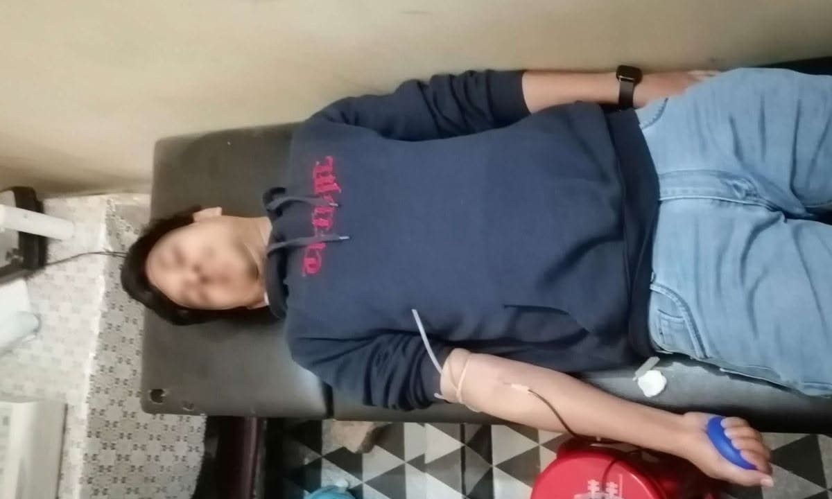 Donor squeezing a pump ball during donation.
