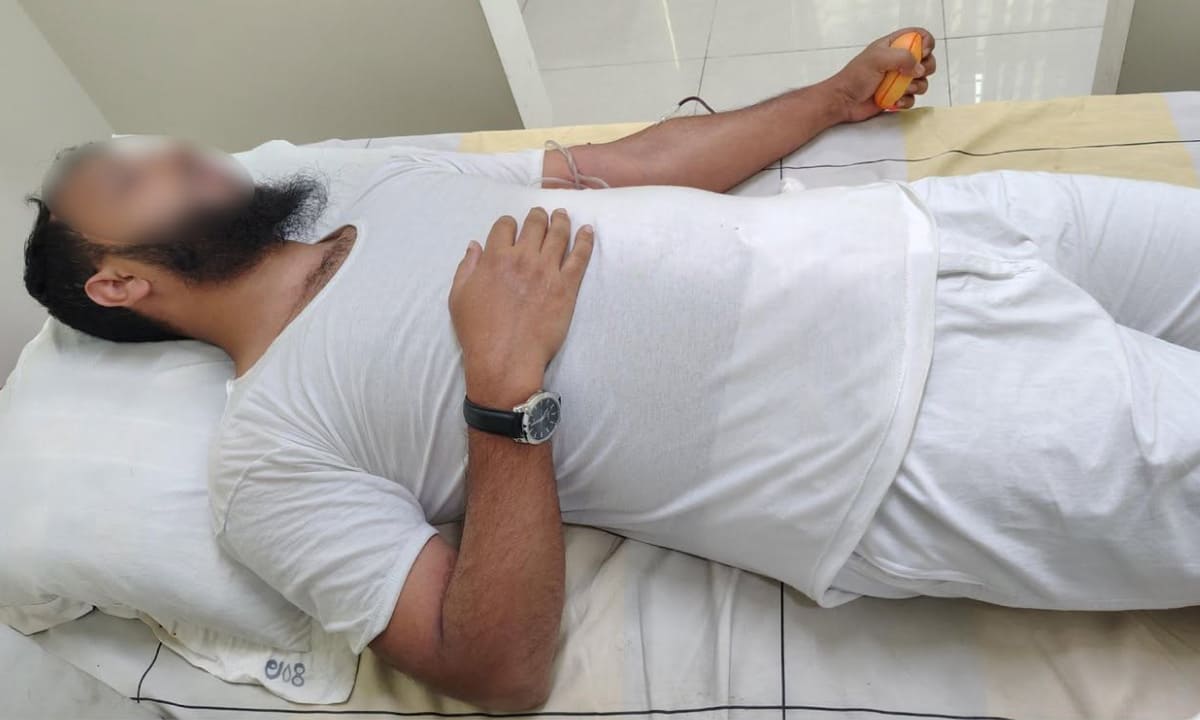 Donor resting in a hospital ward during donation.
