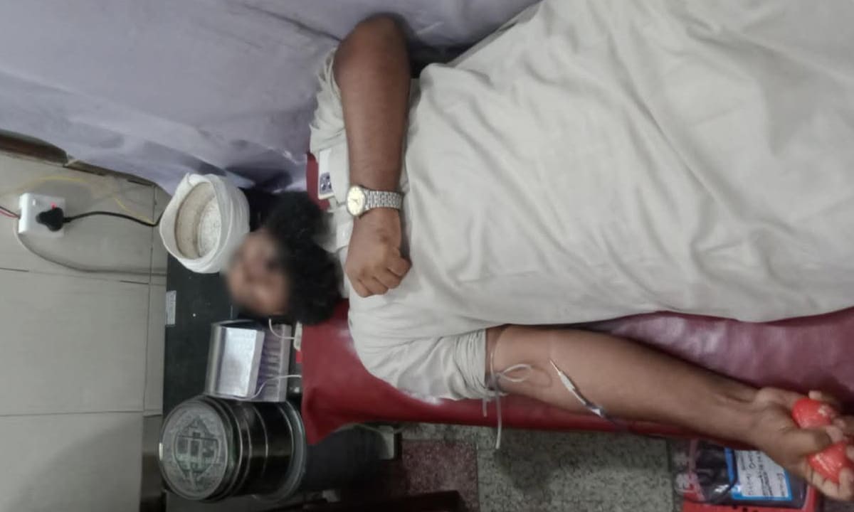 Donor holding a stress ball during donation.
